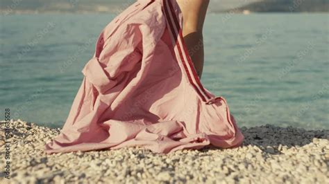 Slow Motion Video Of A Girl Taking Off Her Shirt And Going Into The Sea