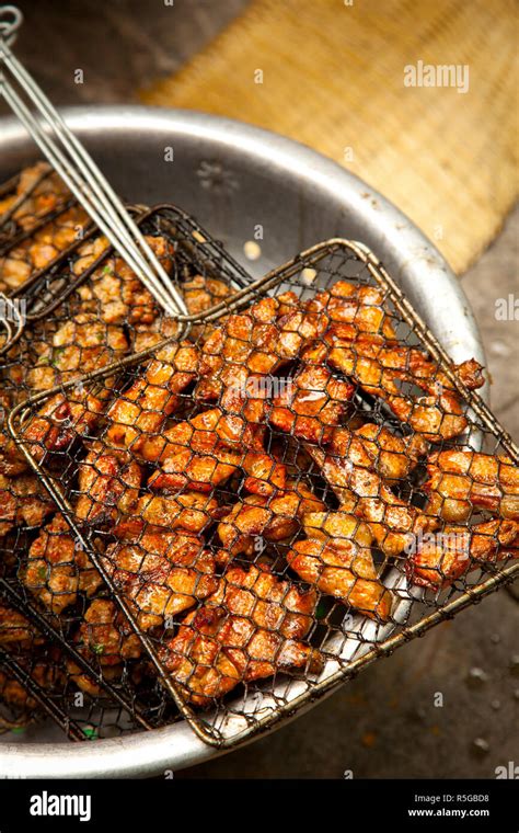 Preparing grilled pork as part of Bun Cha Street food, Old Quarter ...