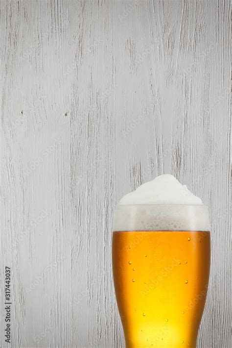 Beer splash in glass on vintage background with copy space Stock Photo | Adobe Stock