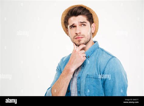 Thoughtful Handsome Young Man Standing And Thinking Over White