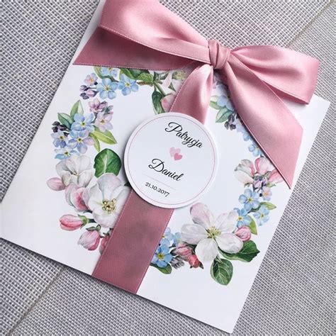 A Card With Pink Ribbon And Flowers On It