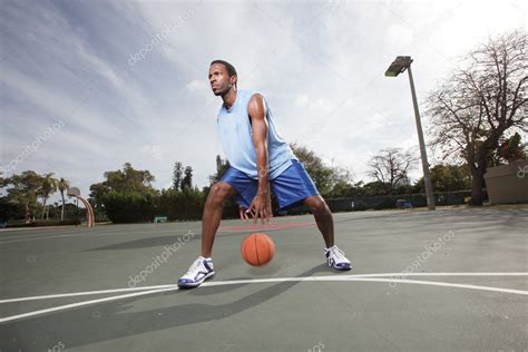 Basketball Player Dribbling The Ball Stock Photo By ©felixtm 8862286