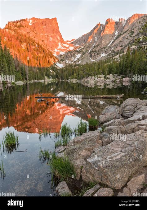 The First Reddish Light Of Alpenglow Hits Hallett Peak Reflected In