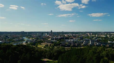 View of the skyline of Vilnius city through the trees of the park at ...