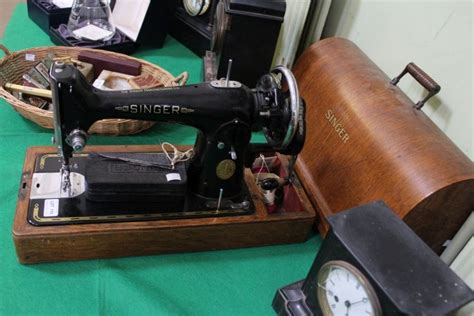 A Cased Singer Sewing Machine With Accessories