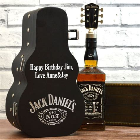 a guitar case with a bottle of jack daniels on it and a happy birthday sign