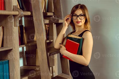 Young Woman Librarian In The Glasses Posing With A Book 16497938 Stock