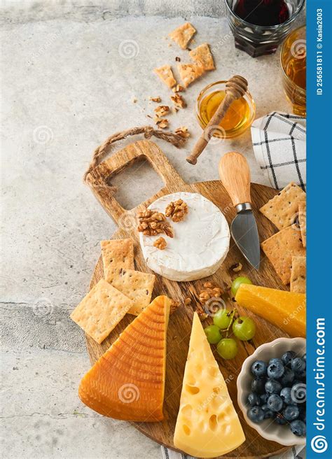 Assortment Of Cheese Honey Cracker Blueberries Grapes With Red And