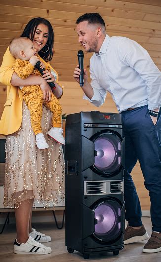 Young Parents With Their Baby Boy Singing Karaoke At Home Stock Photo - Download Image Now - iStock