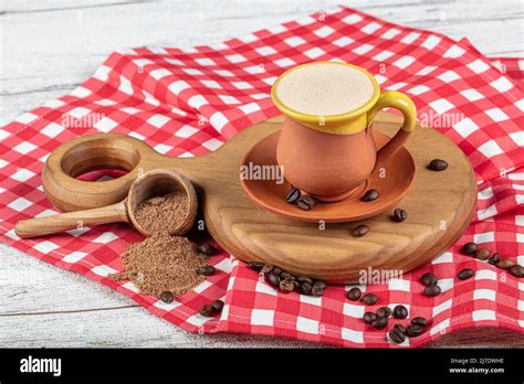 Traditional Turkish Dibek coffee in coffee cup on wooden table. Turkish ...