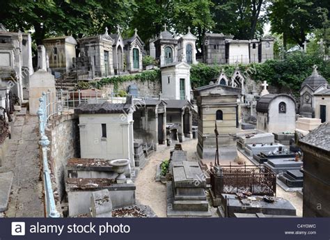 An Old Cemetery With Many Headstones And Trees