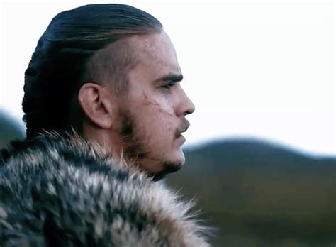 A Man Wearing A Fur Coat With Mountains In The Background