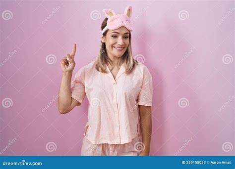 Blonde Caucasian Woman Wearing Sleep Mask And Pajama Showing And