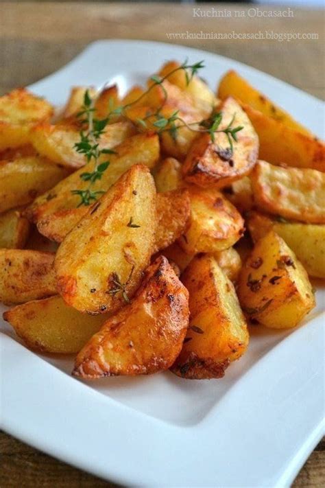 A White Plate Topped With Fried Potatoes Covered In Seasoning And