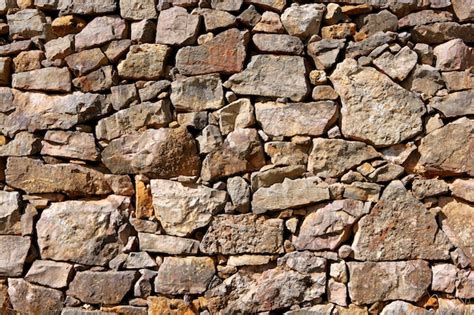 Textura de la pared de piedra de mampostería antigua arquitectura