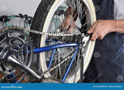 Bicycle Repair. Closeup of a Mechanic Tightening the Rear Wheel of a ...