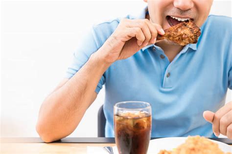 Man Eating Chicken Stock Photos, Pictures & Royalty-Free Images - iStock