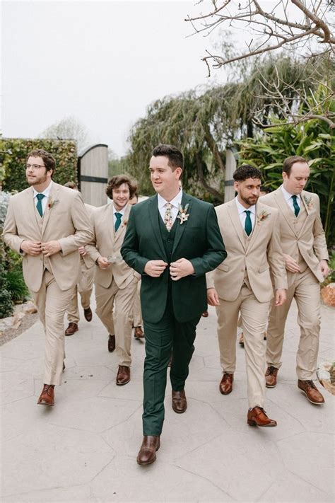 A Group Of Men In Suits And Ties Walking Down A Sidewalk With One Man