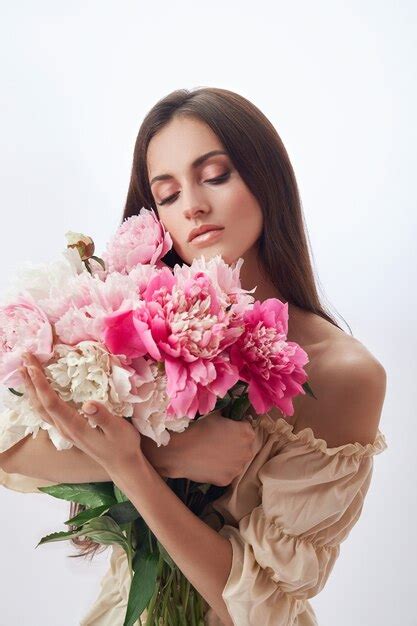 Premium Photo Beautiful Woman With Lots Of Pink Flowers In Her Hands