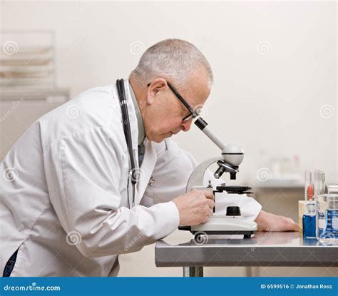 Scientist In Lab Coat Putting Vial With Sample Into Autosampler Of Hplc