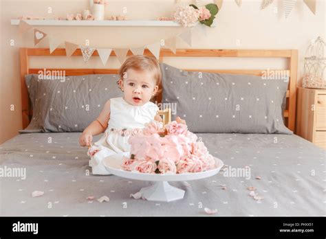Portrait Of Cute Adorable Caucasian Blonde Baby Girl In White Dress Celebrating Her First