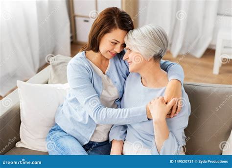 Senior Mother With Adult Daughter Hugging At Home Stock Image Image