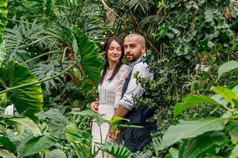 Premium Photo Beautiful Couple Girl And Guy In The Park Among Tropical Trees