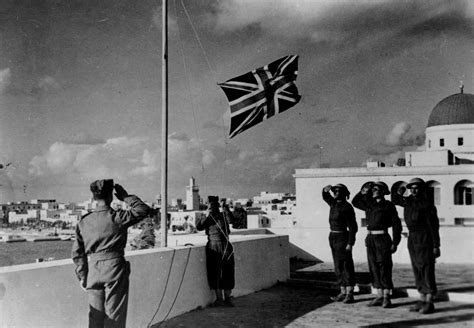 British soldiers salute the Union Flag as it is hoisted on an Italian ...