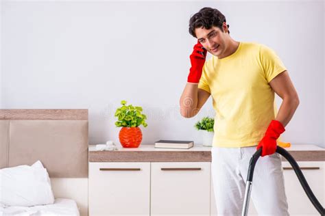 The Young Handsome Man Cleaning In The Bedroom Stock Photo Image Of