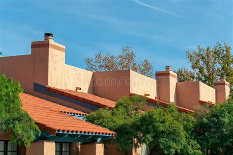 Adobe Style Rooftops On Apartment Building Or Condo With Chimneys And