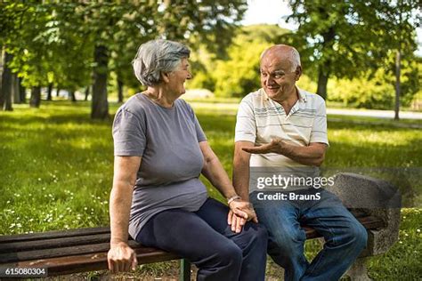 Old Couple Sitting On A Bench Photos And Premium High Res Pictures