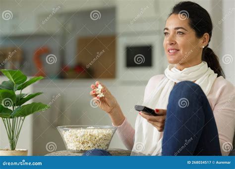 Happy Woman Eating Popcorn While Watching Television Stock Image