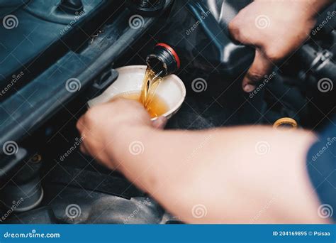 Mechanic Pouring Oil To Vehicle Engine Serviceman Changing Motor Oil