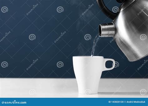 Pouring Hot Water Into Into A Cup On A Dark Background Cup Of Tea With