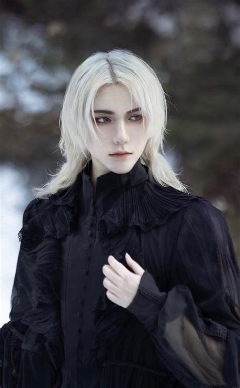 A Woman With White Hair And Black Clothes