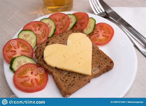 Heart Shaped Cheese Sandwich With Vegetables On White Plate Stock