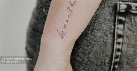 La Vie Est Belle Lettering Tattoo On The Wrist