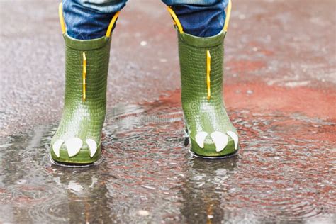 Child with Rain Boots Jumps into a Puddle Stock Image - Image of ...