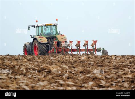 Tractor And Plough Attached Various Shots Of Tractor Ploughing A Field