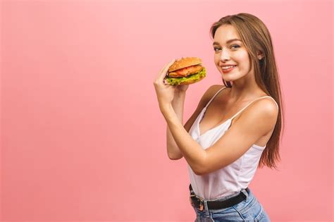 Retrato De Joven Hermosa Mujer Hambrienta Comiendo Hamburguesa Foto