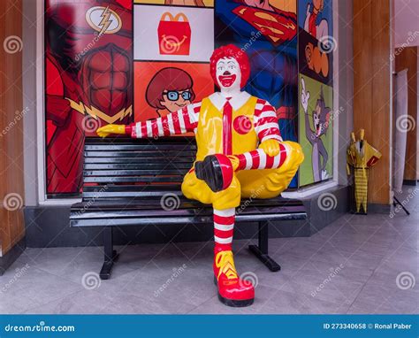 Portrait Of Of Ronald Mcdonald Sitting On Bench In Front Of Mcdonald S