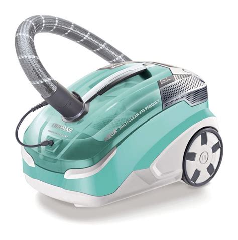 A Green And White Vacuum Cleaner On A White Surface