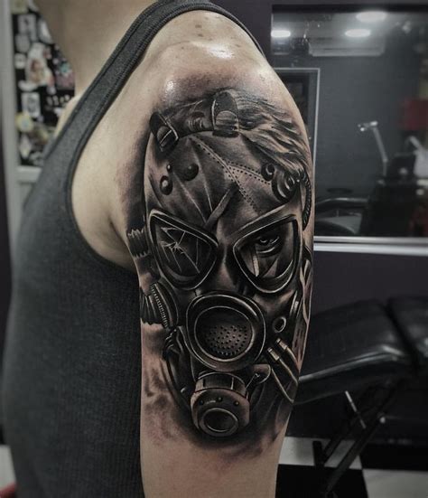 A Man With A Gas Mask Tattoo On His Arm