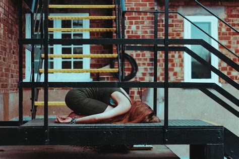 Premium Photo Woman Relaxing On Built Structure In City