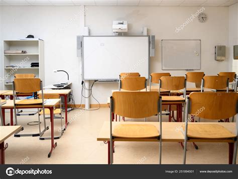 Empty classroom with an interactive whiteboard, desks and chairs Stock Photo by ©fermate 251894501