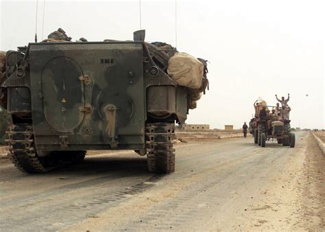 Iraqi Civilians Prepare To Drive Past The Marine Assault Amphibian