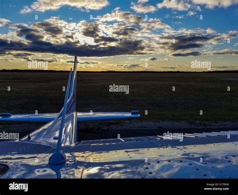 Airplane sunset clouds Stock Photo - Alamy