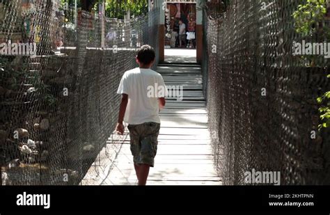 Boy Walks Across Foot Bridge Puerto Vallarta Mexico Hd Stock Video