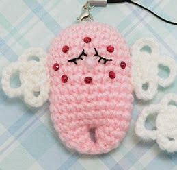 A Crocheted Keychain With An Adorable Pink Object On It S Side