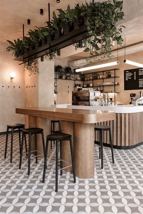 The Interior Of A Coffee Shop With Plants Hanging From The Ceiling And